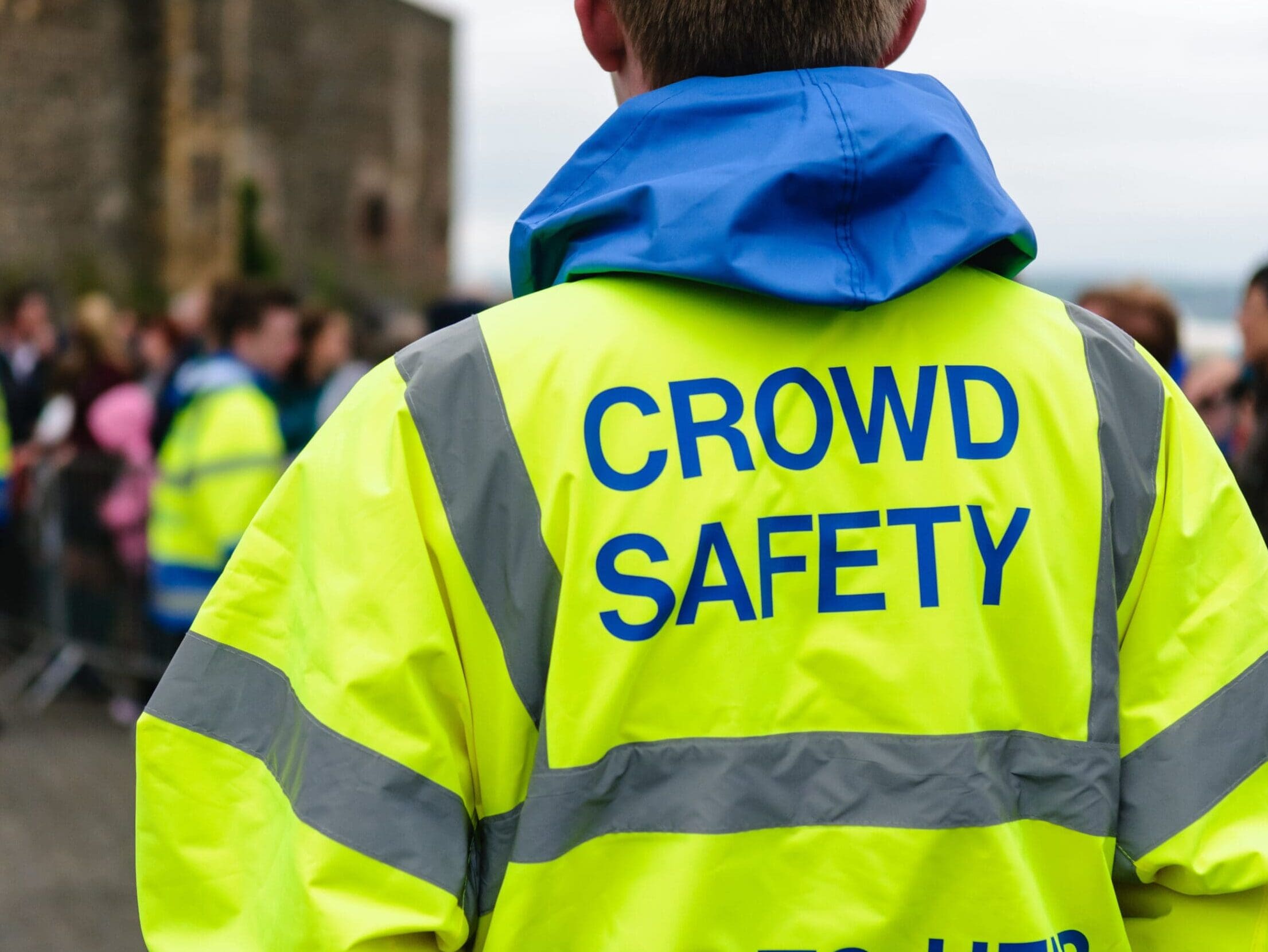 Crowd safety officer in high visibility jacket