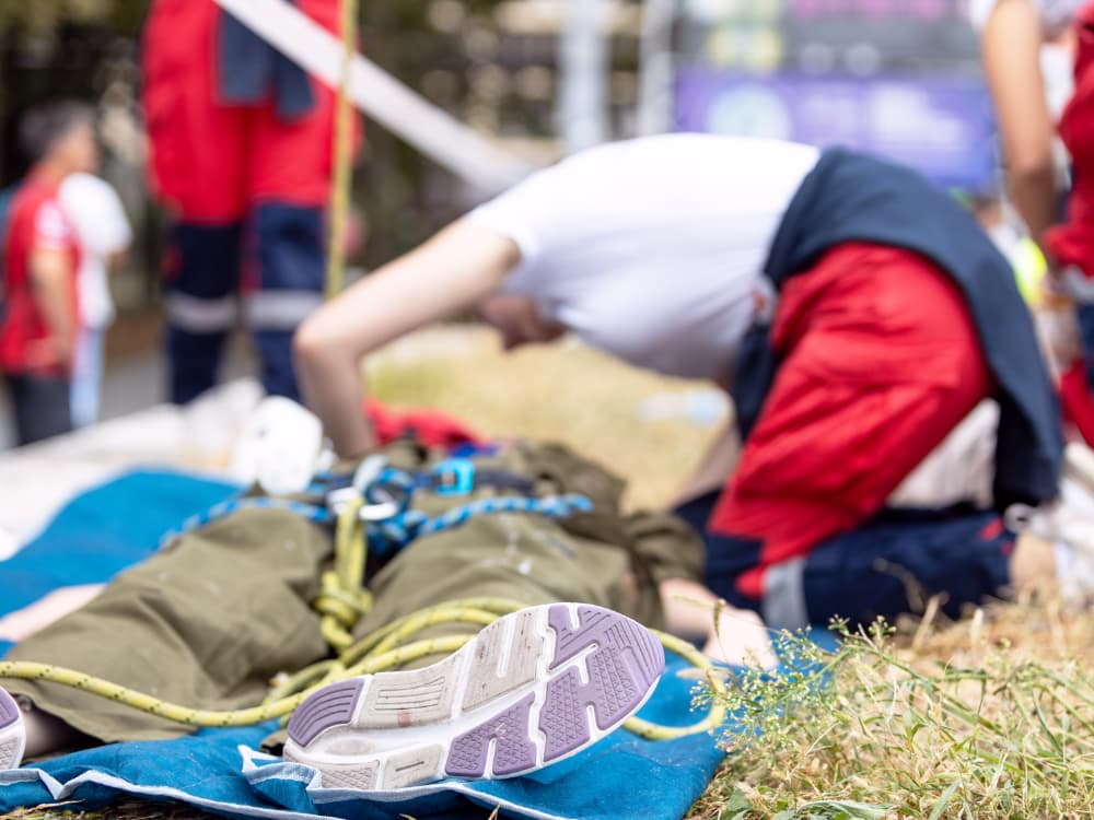 A woman attending to a person on the ground.