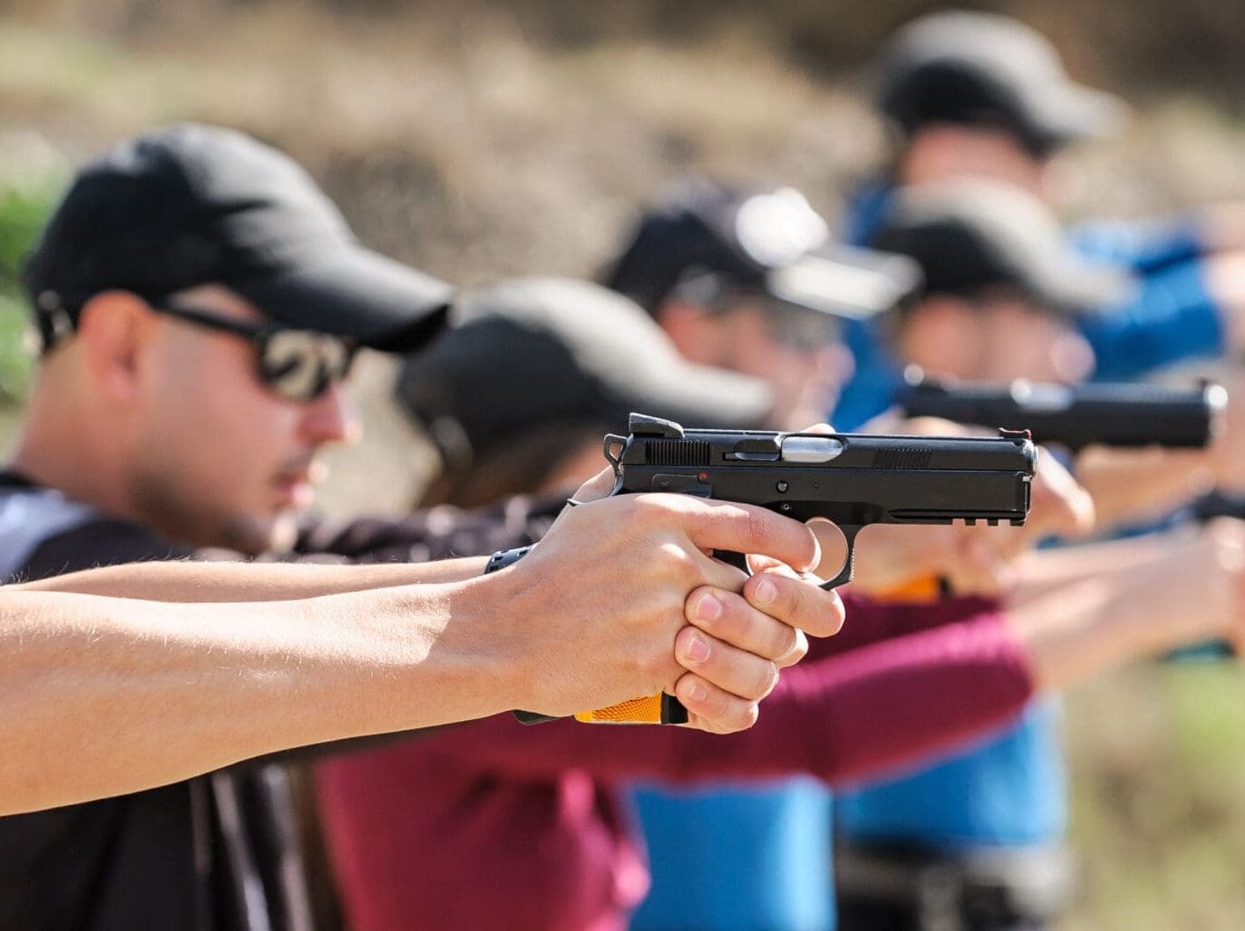 Young people on tactical gun training classes. Shooting and Weapons. Outdoor Shooting Range